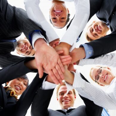 Teamwork and team spirit - Hands piled on top of one another .