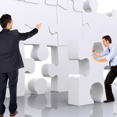business teamwork - business men making a puzzle